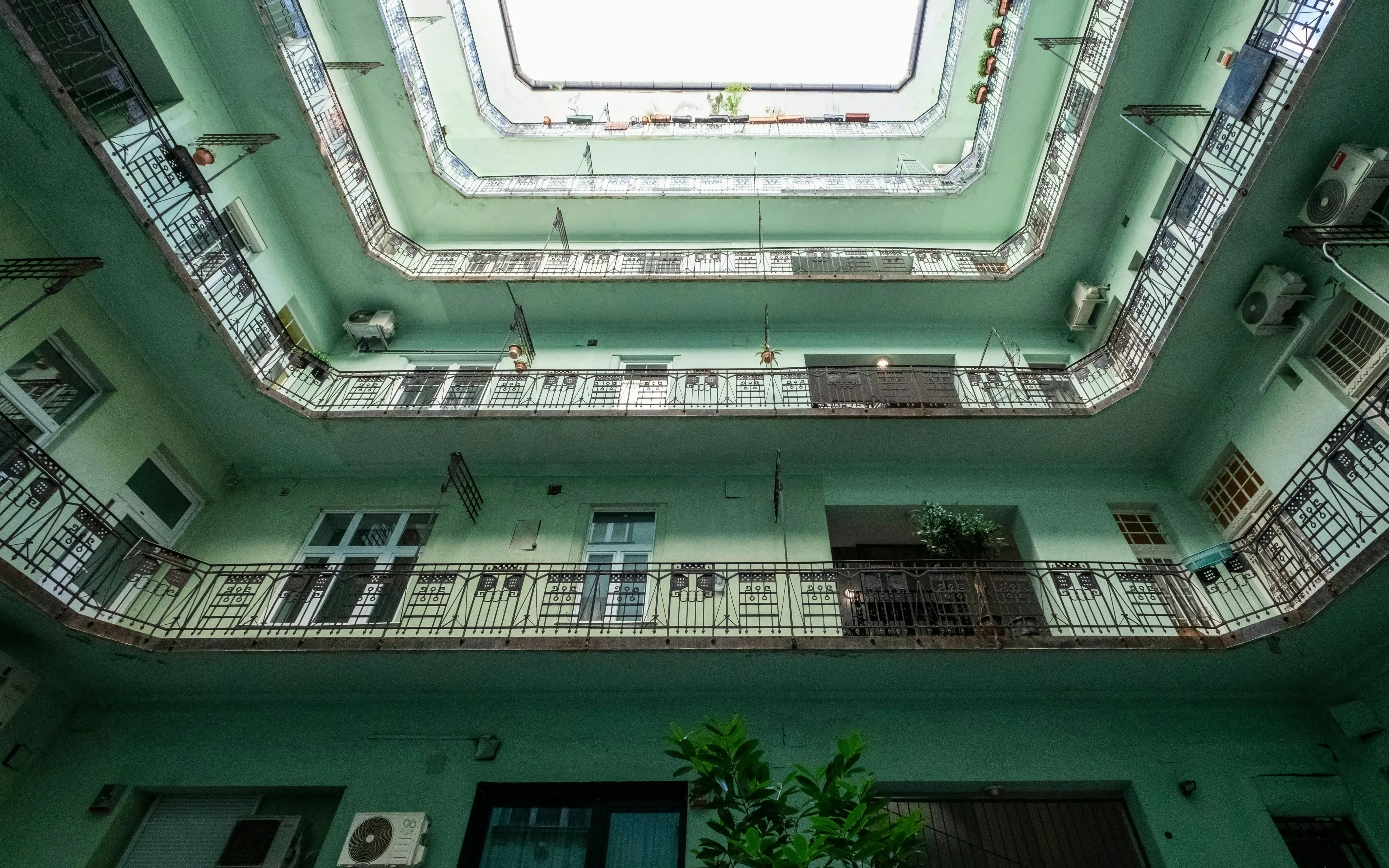 Courtyard view of Art Nouveau building in Budapest's Jewish Quarter, showcasing Hungarian Secessionist architecture.