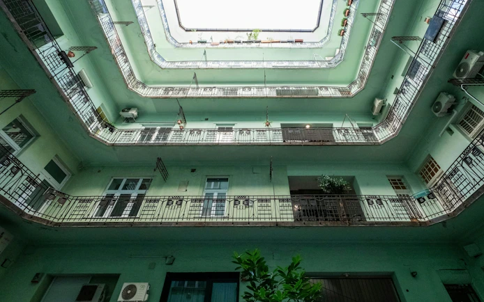 Courtyard view of Art Nouveau building in Budapest's Jewish Quarter, showcasing Hungarian Secessionist architecture.