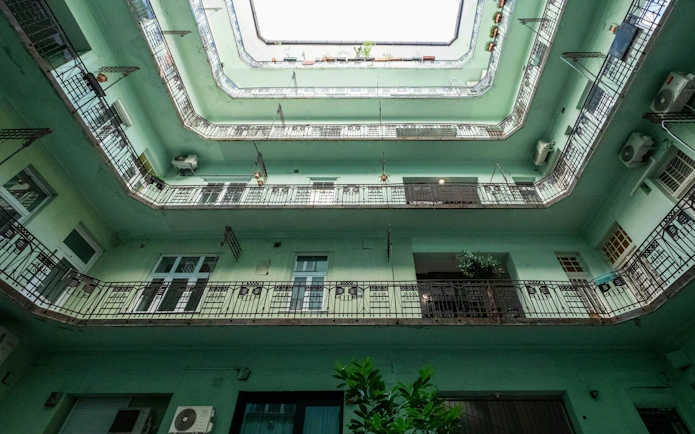 Courtyard view of Art Nouveau building in Budapest's Jewish Quarter, showcasing Hungarian Secessionist architecture.