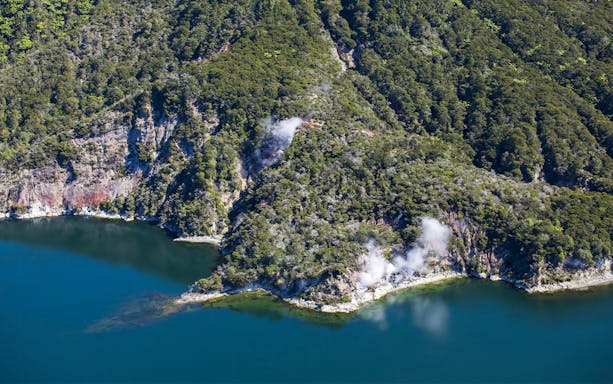 Aerial view of Mount Tarawera's geothermal landscape with steam vents near Orakei Korako, New Zealand.