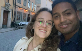 Couple smiling on a cobblestone street in Stockholm during The Troll Escape city exploration game.