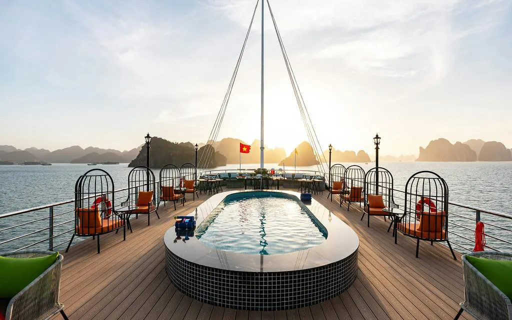 Luxury deck of La Casta cruise with pool, Ha Long Bay in the background.