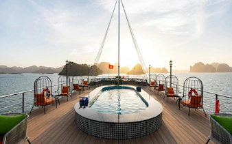 Luxury deck of La Casta cruise with pool, Ha Long Bay in the background.