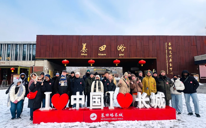 Group of tourists at Mutianyu Great Wall entrance with "I Love China" sign.
