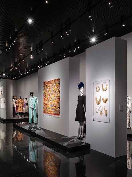 Fashion exhibit at YSL Museum in Marrakech showcasing designer clothing and accessories.
