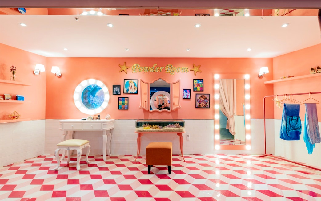 Powder room at SEA LIFE Busan Aquarium with vanity, mirror, and colorful decor.