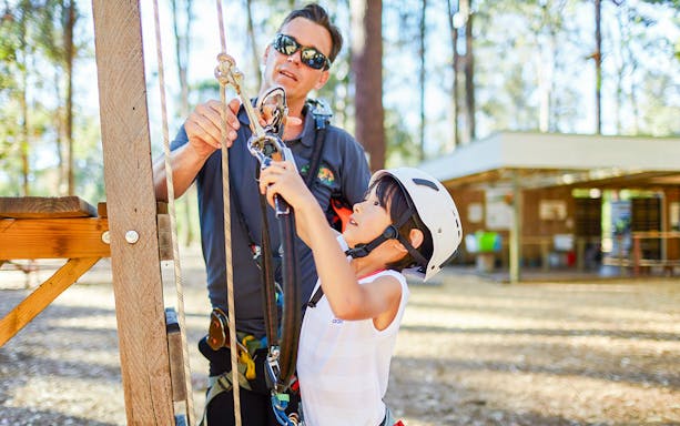 Child learning rope climbing at Ludlow Tuart Forest, Western Australia.