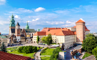 Wawel Castle complex in Krakow, featuring historic architecture and lush gardens.