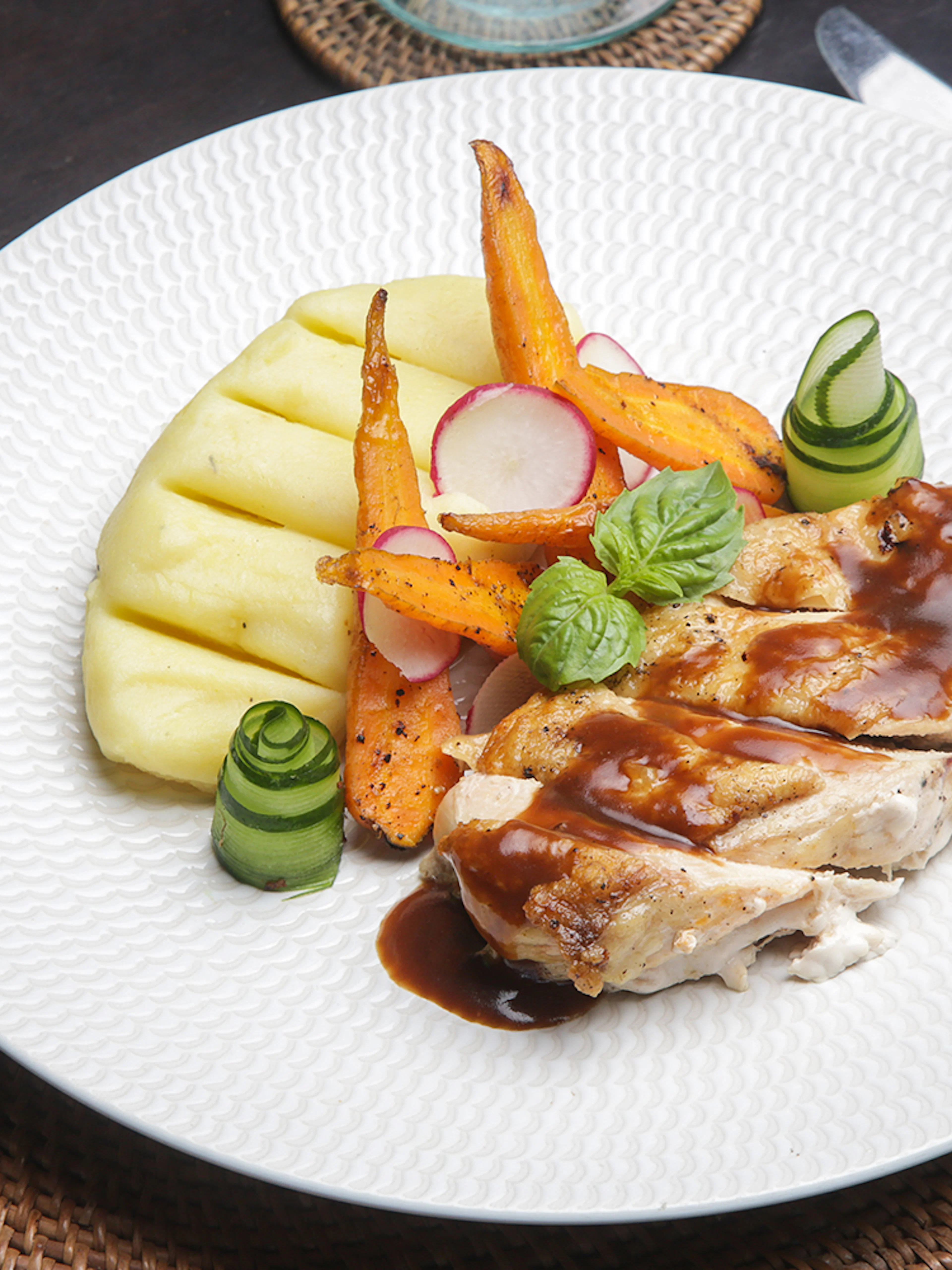 Pork with grilled vegetables and mashed potatoes on Berlin dinner cruise plate.