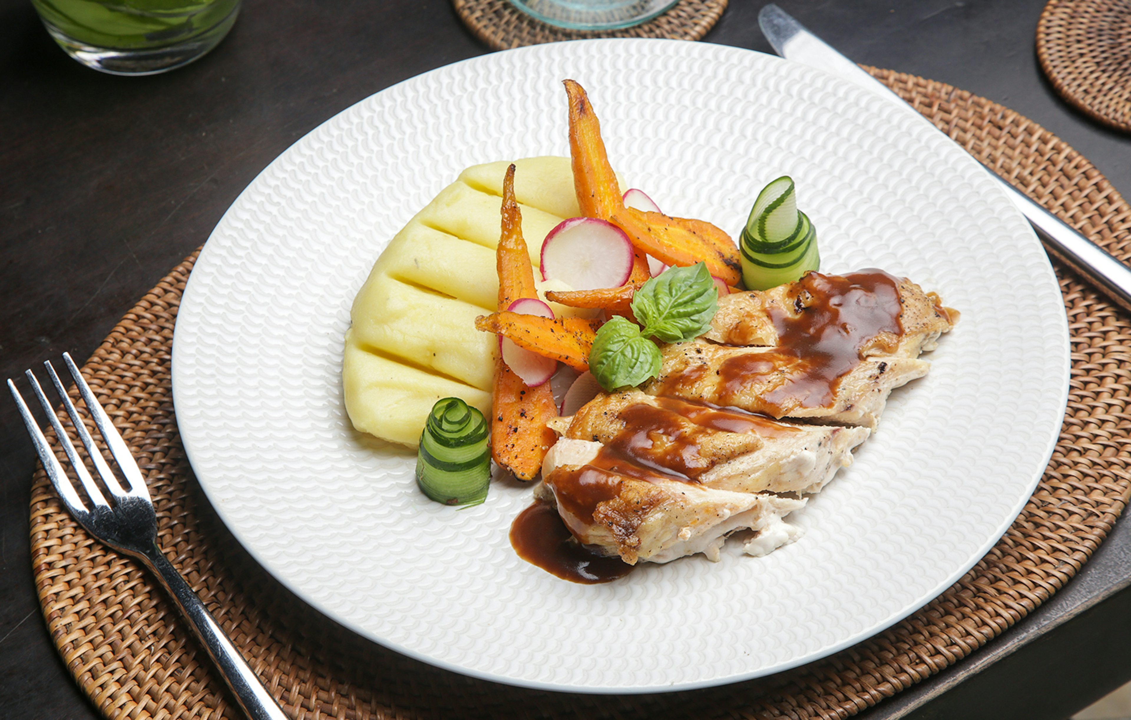 Pork with grilled vegetables and mashed potatoes on Berlin dinner cruise plate.