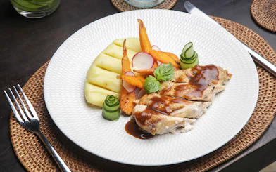 Pork with grilled vegetables and mashed potatoes on Berlin dinner cruise plate.