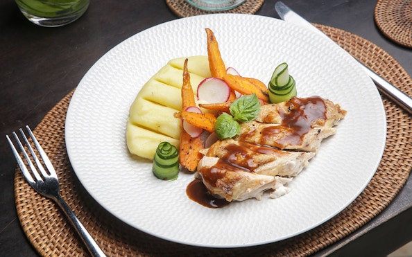 Pork with grilled vegetables and mashed potatoes on Berlin dinner cruise plate.