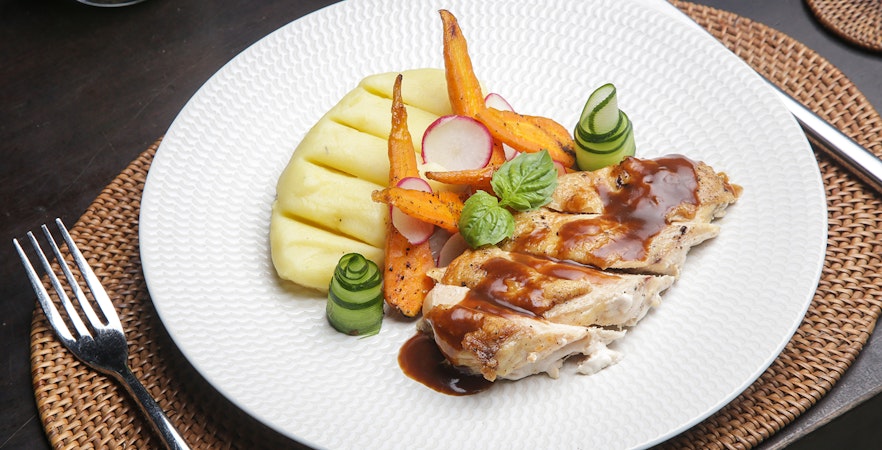 Pork with grilled vegetables and mashed potatoes on Berlin dinner cruise plate.