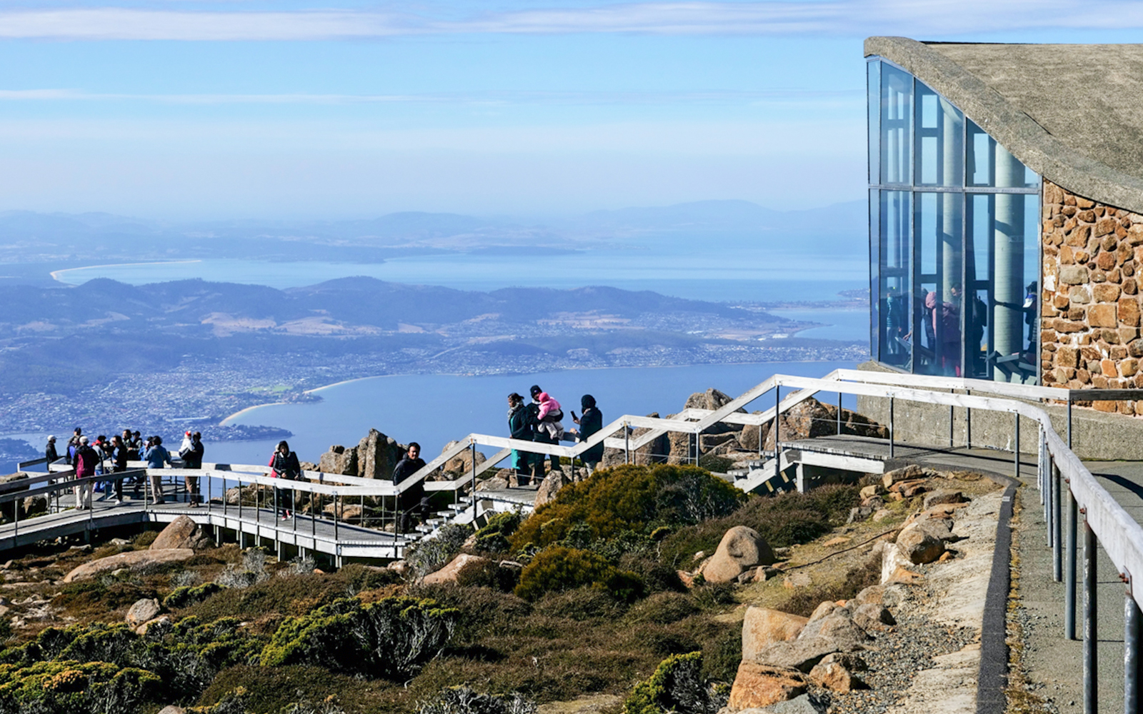 Visitors on a viewing platform at Mount Wellington, Tasmania, overlooking Hobart and the Derwent River.