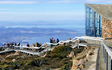 Visitors on a viewing platform at Mount Wellington, Tasmania, overlooking Hobart and the Derwent River.