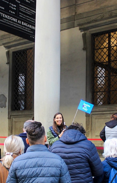 Visitors exploring art exhibits at Uffizi Gallery, Florence, during a private tour.