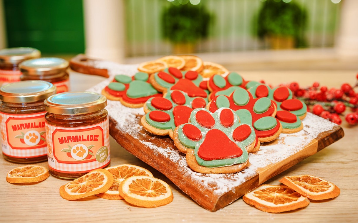 Paw-shaped cookies and marmalade jars at Christmas Paddington experience, London.