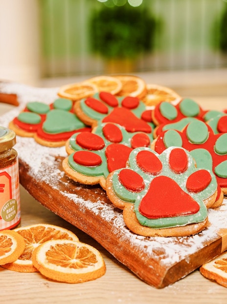 Paw-shaped cookies and marmalade jars at Christmas Paddington experience, London.