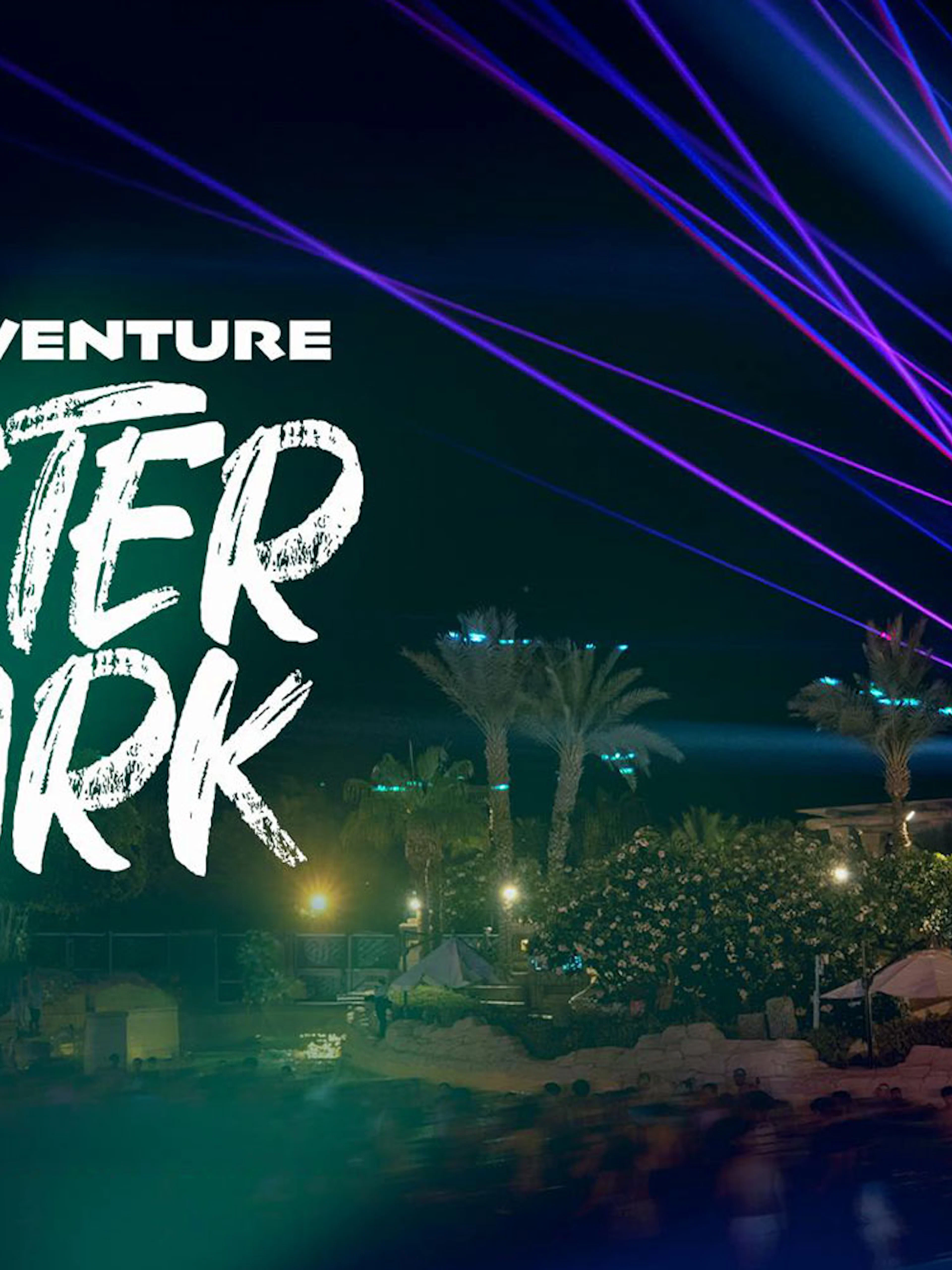 Aquaventure After Dark 2026 event with laser lights and palm trees at night.