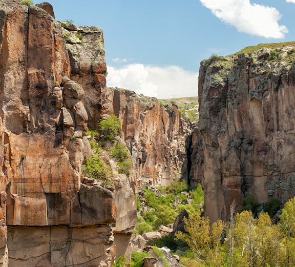 Ihlara Valley canyon with steep rock walls and lush greenery, Cappadocia, Turkey.