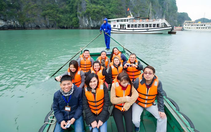Tourists in life jackets on a boat during Ha Long Phoenix Cruise in Halong Bay, Vietnam.
