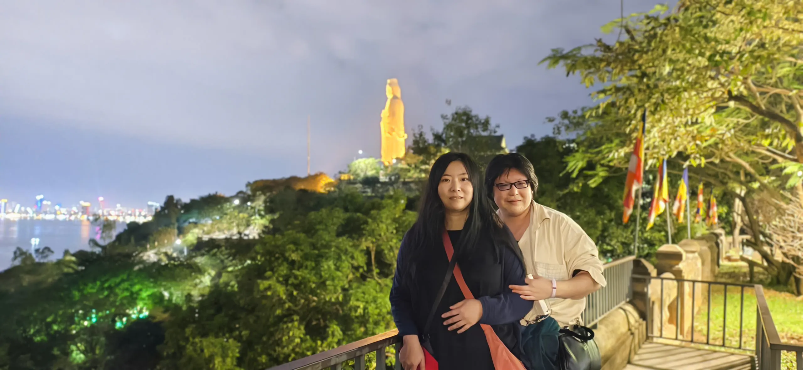 Couple at Lady Buddha statue viewpoint, Da Nang, during coastal charm cafe tour.