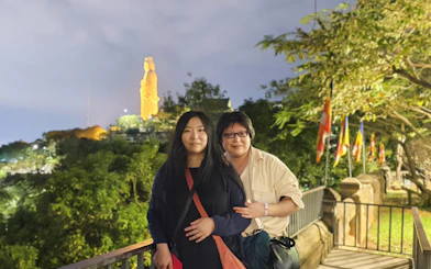 Couple at Lady Buddha statue viewpoint, Da Nang, during coastal charm cafe tour.