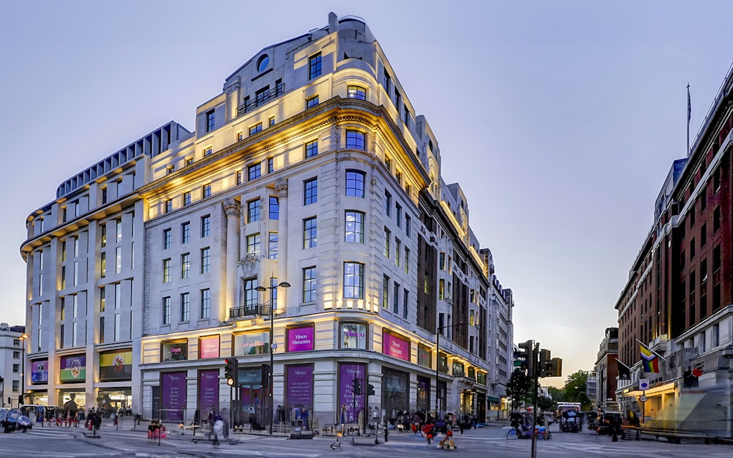 Moco Museum London entrance on a busy street corner at dusk.