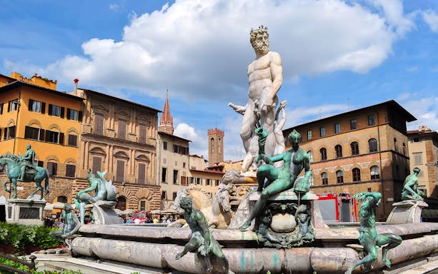 Neptune Fountain in Piazza della Signoria, Florence, with historic buildings in the background.