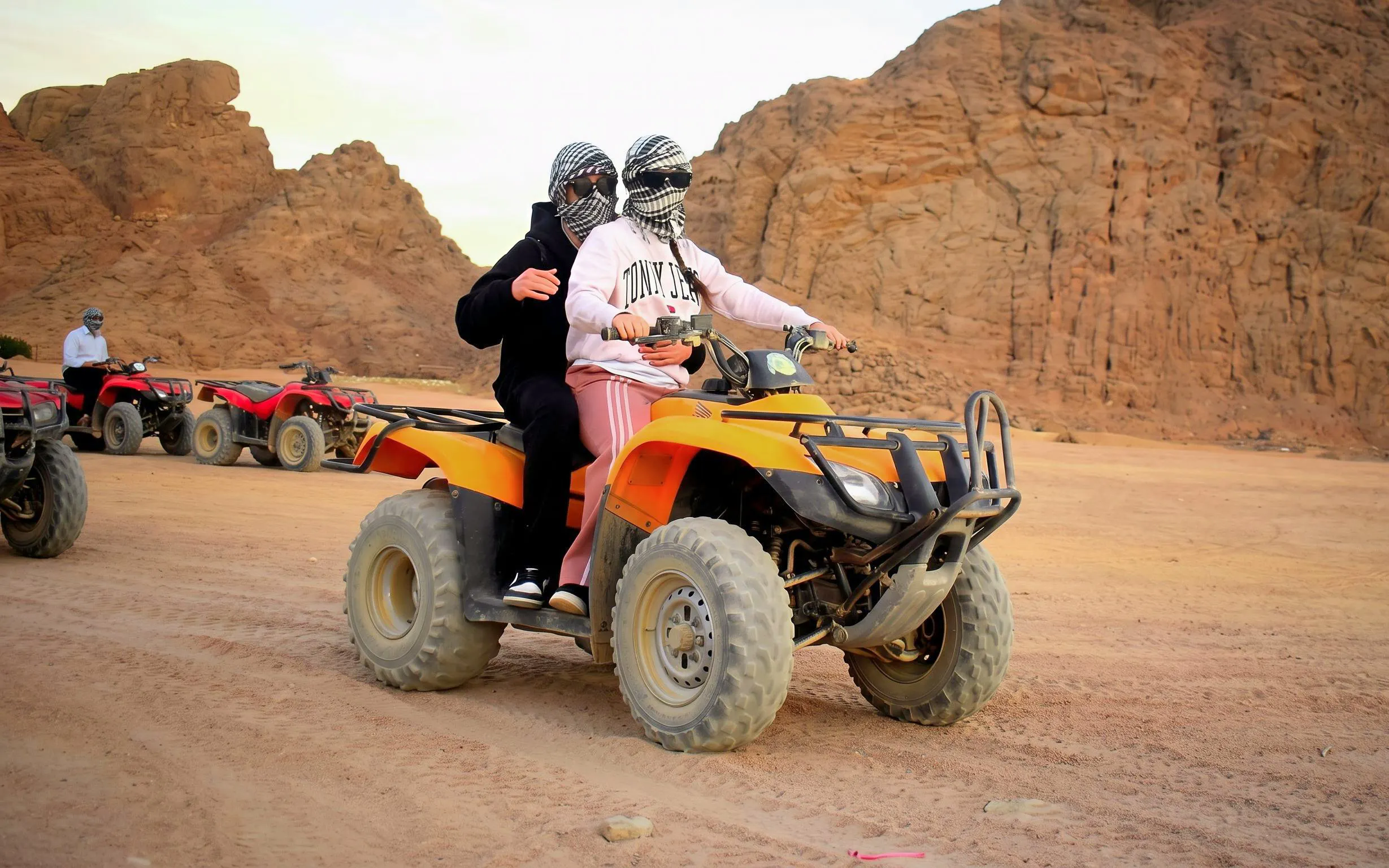 Quad biking in the Sinai Desert, Sharm El Sheikh, with rocky landscape in the background.