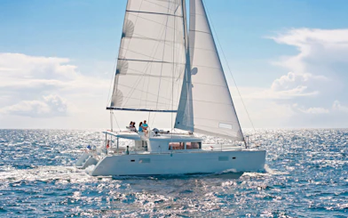 Catamaran sailing in Heraklion with passengers enjoying an onboard chef experience.