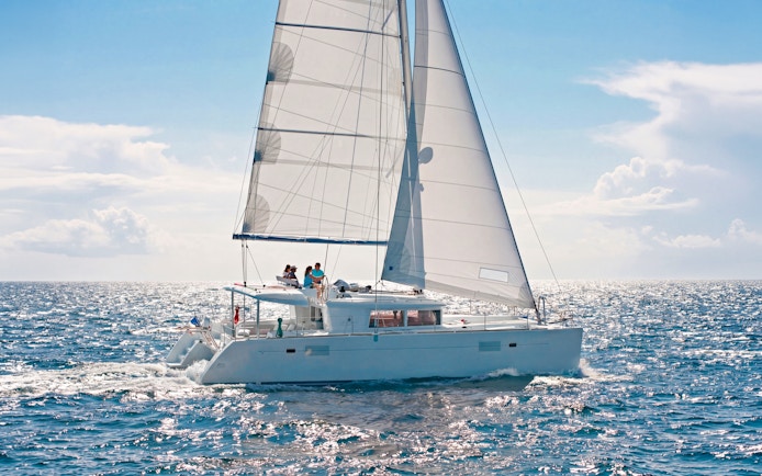 Catamaran sailing in Heraklion with passengers enjoying an onboard chef experience.
