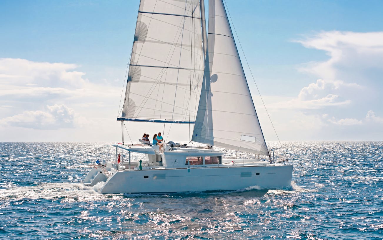 Catamaran sailing in Heraklion with passengers enjoying an onboard chef experience.