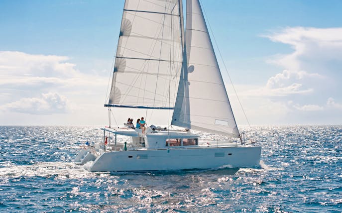 Catamaran sailing in Heraklion with passengers enjoying an onboard chef experience.