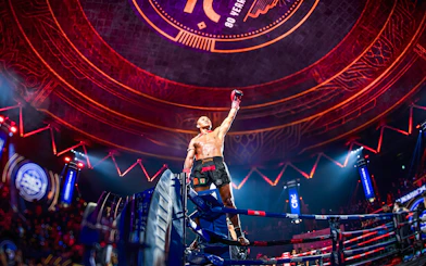 Muay Thai fighter celebrating victory at Rajadamnern Stadium, Bangkok.