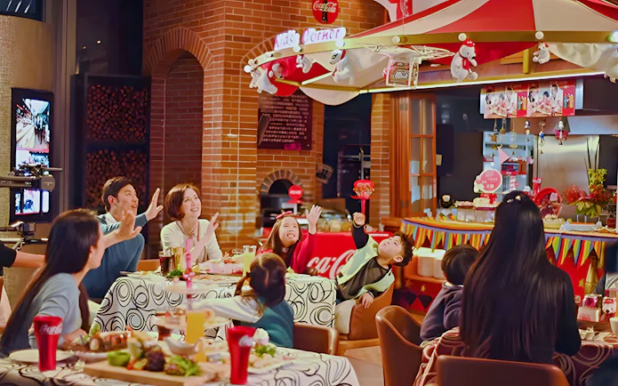 Family dining at Coca-Cola Happy Restaurant Buffet, Oriental Pearl Tower, Shanghai.