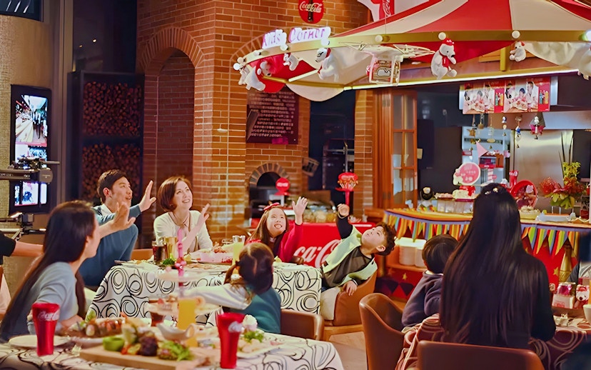 Family dining at Coca-Cola Happy Restaurant Buffet, Oriental Pearl Tower, Shanghai.