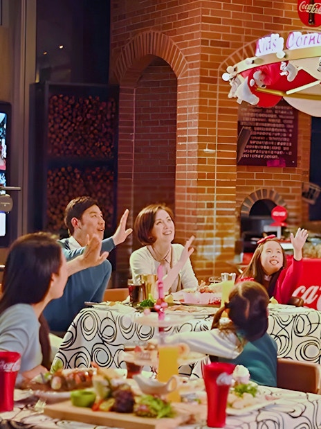 Family dining at Coca-Cola Happy Restaurant Buffet, Oriental Pearl Tower, Shanghai.