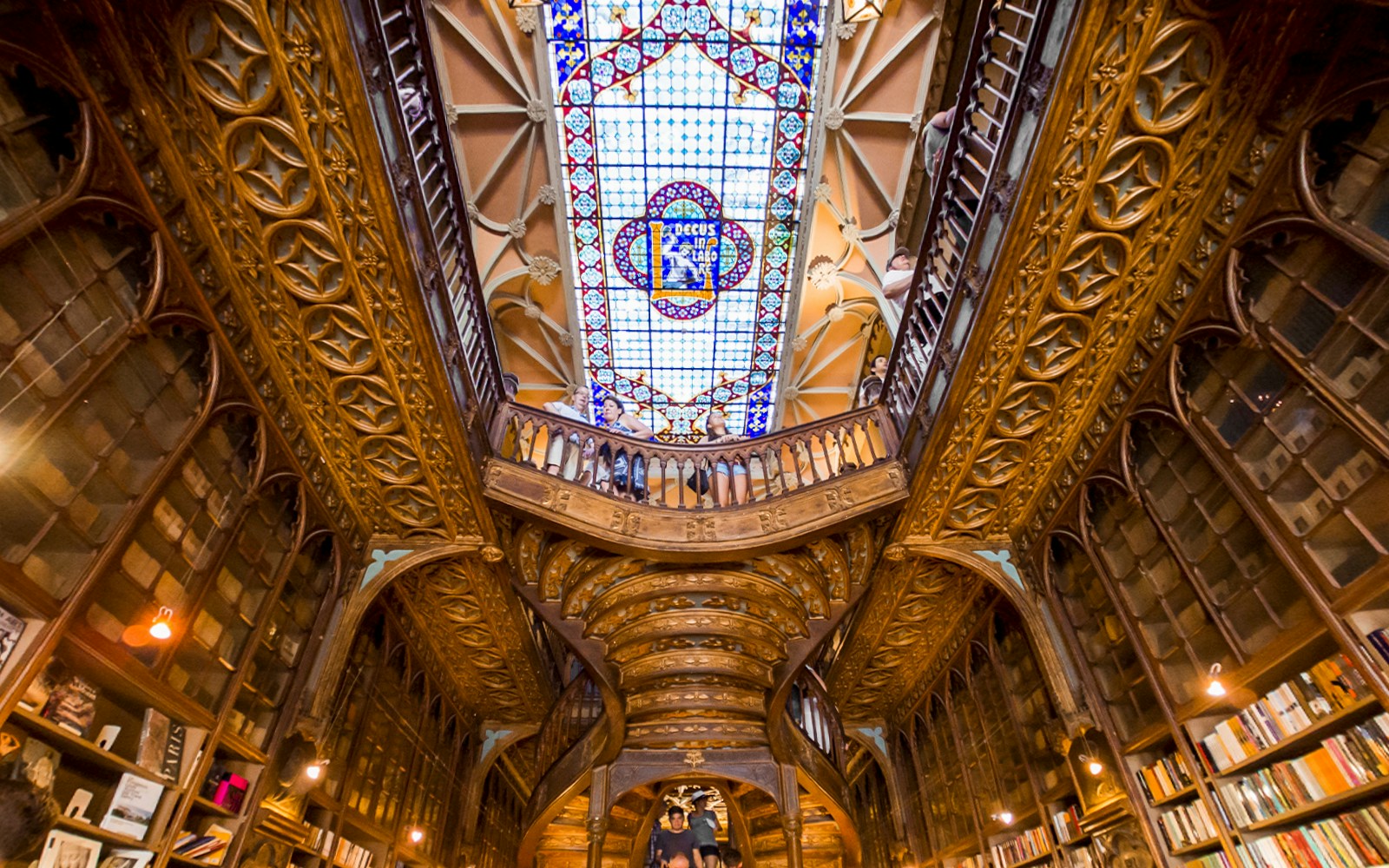 Lello Library's ornate staircase and stained glass ceiling in Porto, Portugal.