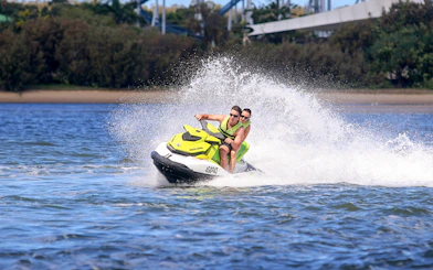 Jet ski riders speeding on water during a Jet Ski & Parasail Experience.
