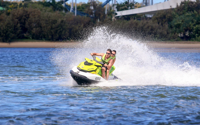 Jet ski riders speeding on water during a Jet Ski & Parasail Experience.