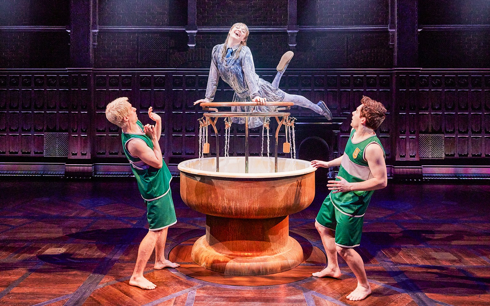 Actors performing a scene from "Harry Potter and the Cursed Child" on stage.