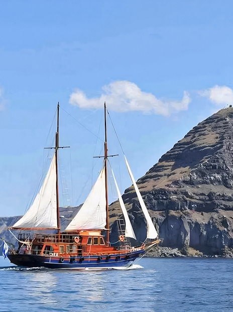Sailing boat near volcanic cliffs on Santorini Volcanic Islands tour.