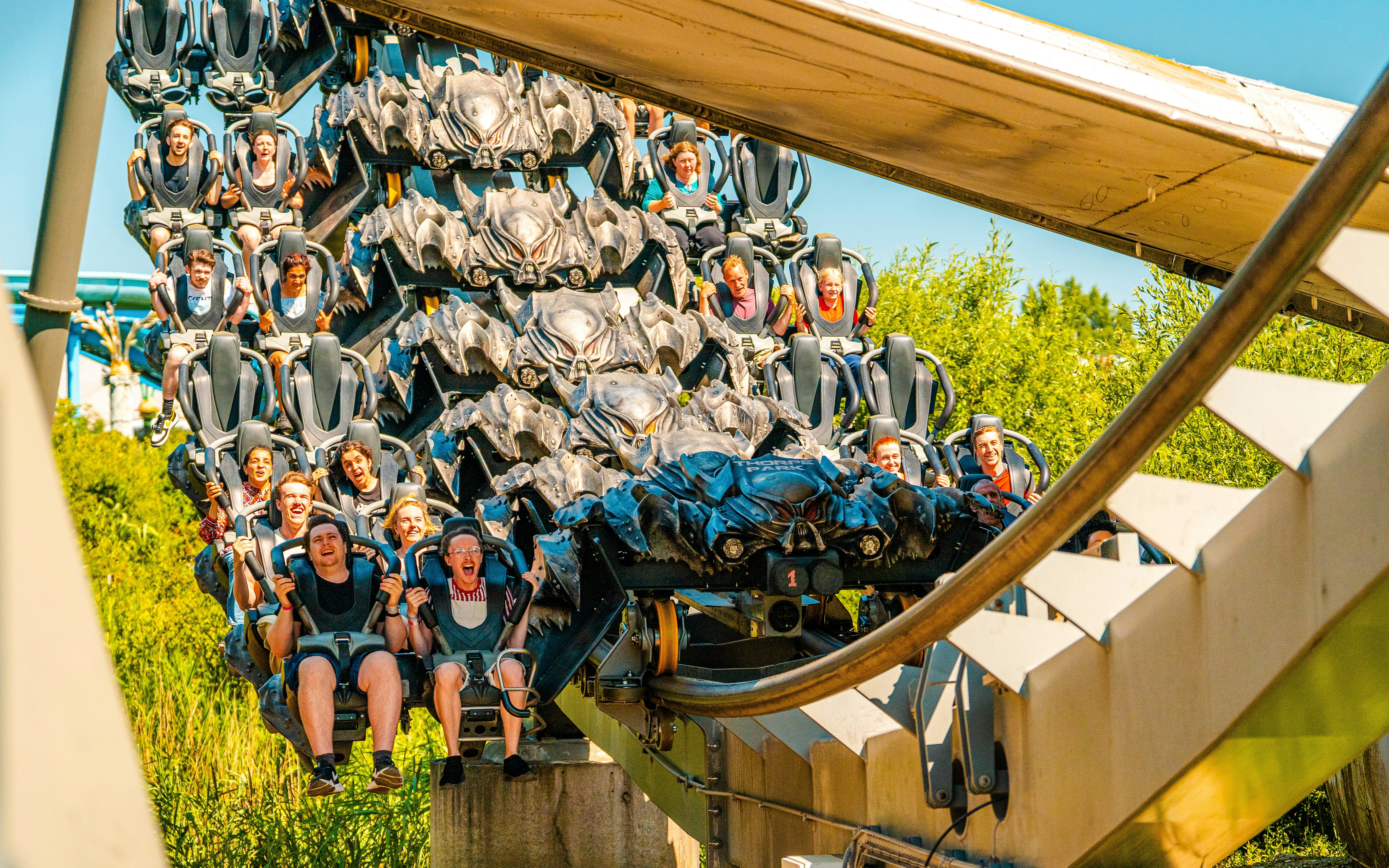 Riders on The Swarm roller coaster at Thorpe Park London, experiencing a thrilling descent.