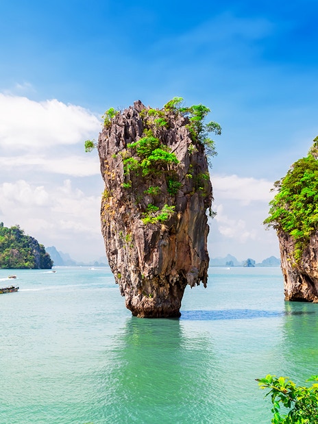 Canoeing near limestone cliffs at James Bond Island, Phang Nga Bay, Thailand.
