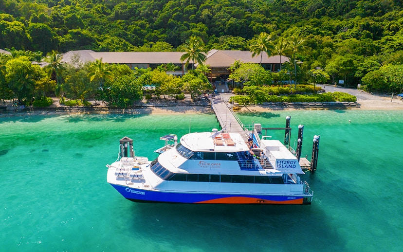 Fitzroy Island ferry docked at lush green island, Cairns day trip.