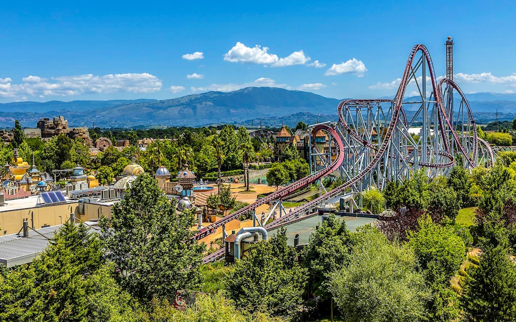 Roller coaster and scenic view at MagicLand Amusement Park.