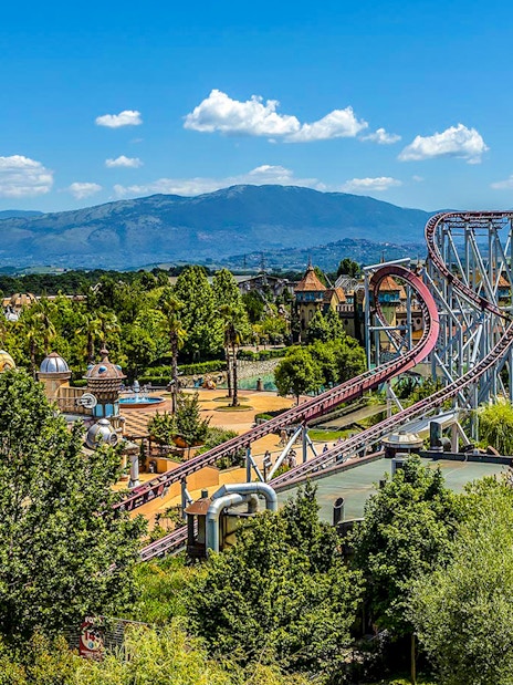 Roller coaster and scenic view at MagicLand Amusement Park.