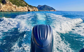 Dinghy cruising in the Gulf of Orosei, view of cliffs and sea from Cala Gonone.
