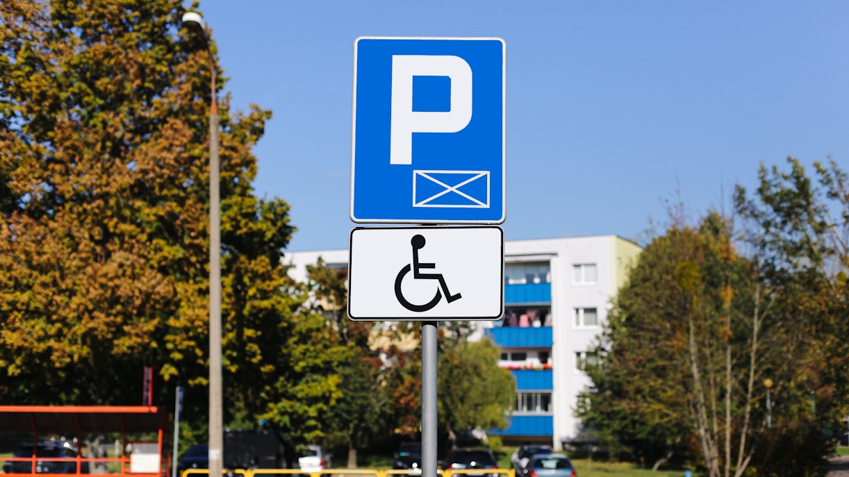 Accessible parking sign for disabled drivers in a residential area.